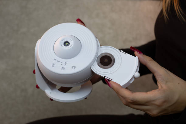Inserting replaceable cartridge with images of planets and stars into galaxy projector