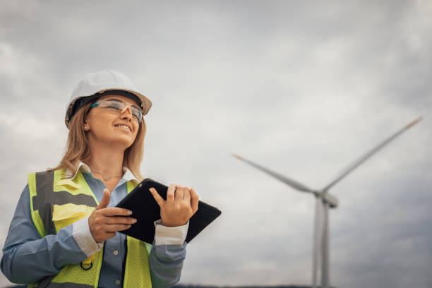 A skilled female engineer is overseeing a vital renewable energy project at a large wind farm, focusing on sustainability initiatives and promoting environmental best practices in the industry