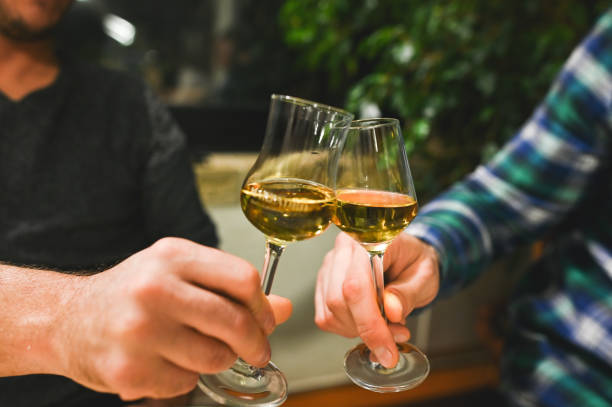 istock Man's hand holding a glass of grappa. 2181314554