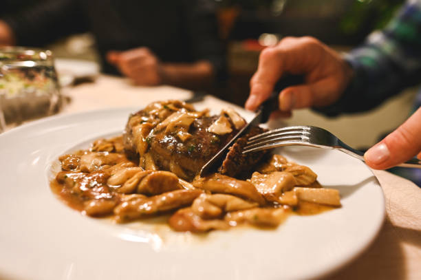 Eating fillet beef with porcini in a restaurant.