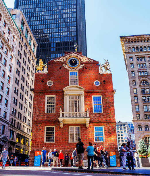Boston, Massachusetts, USA - October 22, 2024: The Old State House building at the intersection of State and Devonshire Streets. Through Massacre, Revolution, and fire, the Old State House stands as the oldest surviving public building in Boston. Built in 1713, the building served as the center of civic, political, and business life. It is one of the landmarks on Boston's Freedom Trail.