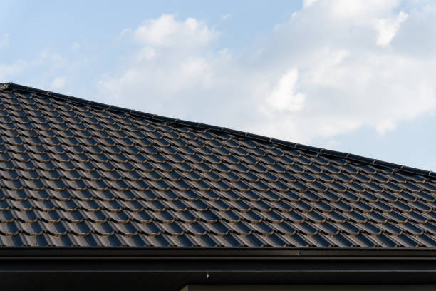 istock The image features a meticulously tiled rooftop with a modern, durable design. The clean layout of the tiles is highlighted against a backdrop of a clear sky, enhancing its aesthetic appeal 2181315340