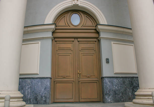 There is a building that has a beautifully crafted wooden door and large columns that create a stunning facade.