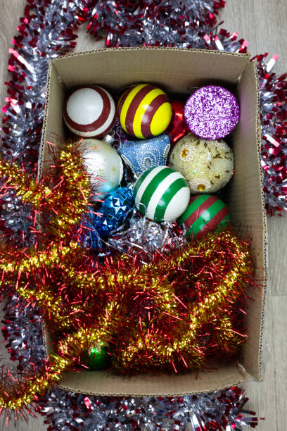 istock Storing Christmas tree decorations in cardboard box, vertical photo 2181317494