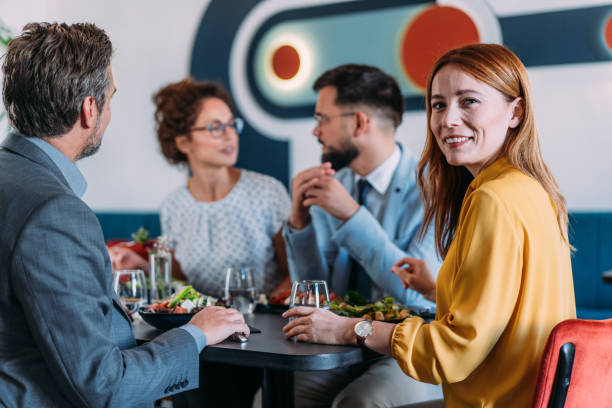 istock Happy business colleagues talking while eating lunch in a restaurant. 2181317874