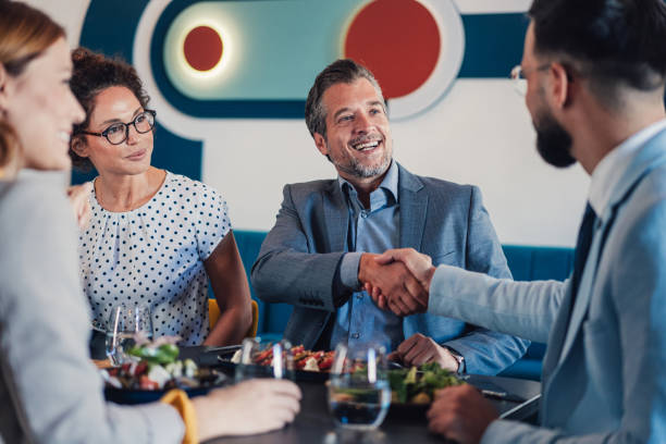 istock Businesspeople shaking hands at the restaurant. 2181317878