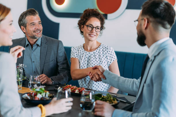 istock Businesspeople shaking hands at the restaurant. 2181317879