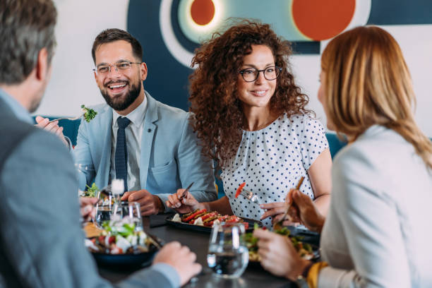 istock Businesspeople having lunch together. 2181317881