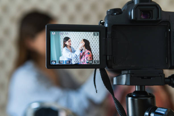 istock Cheerful visagiste applying makeup on model and recording video 2181317905