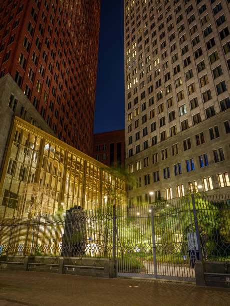 A night shot of a Dutch government building complex. The architecture and illumination highlight the building's significance. Ministry of the Interior, and Ministry of Justice and Security.