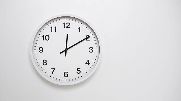 istock Clean White Clock at 00.10 or 12.10 on Minimalist White Background - Ideal for Time Concepts and Modern Design 2181320352