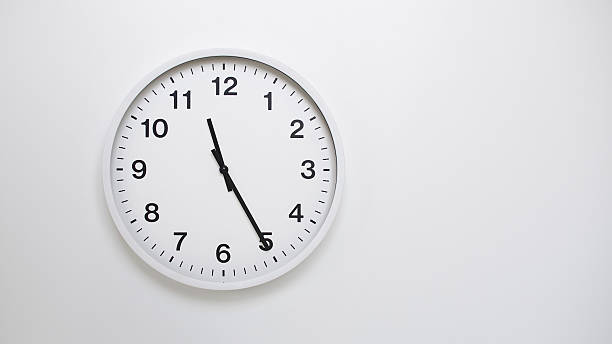 istock Clean White Clock at 11.25 or 23.25 on Minimalist White Background - Ideal for Time Concepts and Modern Design 2181320377