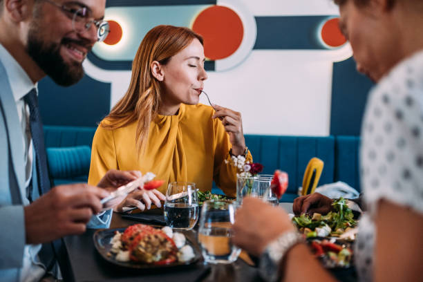 istock Businesspeople having lunch together. 2181322412