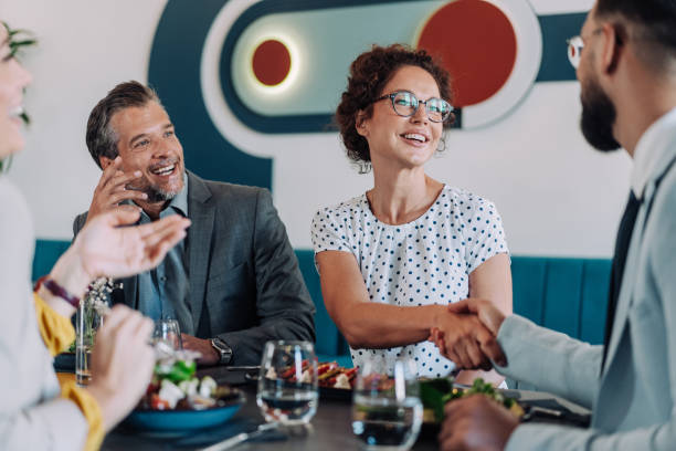 istock Businesspeople shaking hands at the restaurant. 2181322423