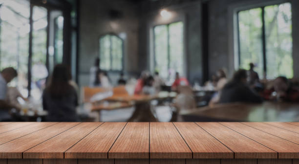 istock Empty wooden table top with lights bokeh on blur restaurant background. 2181333850