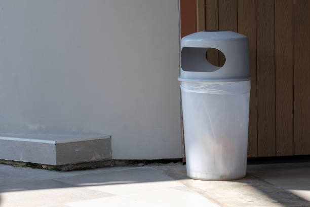istock A trash can with a plastic bag in it is sitting on the sidewalk 2181336225