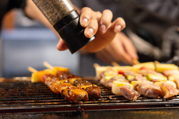 istock A person sprinkling salt on meat on a grill 2181336374