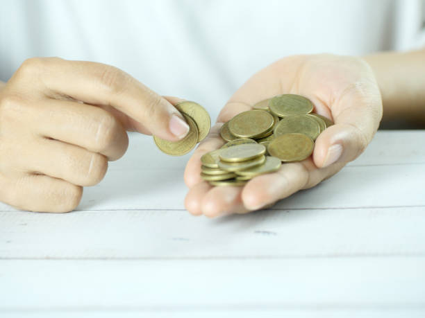 istock Hands counting coins on white background. Finance business concept. Copy space. 2181339537