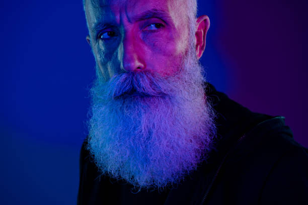 istock Photo of suspicious retired man dressed black pullover anti santa looking empty space copyspace isolated dark blue color background 2181342877