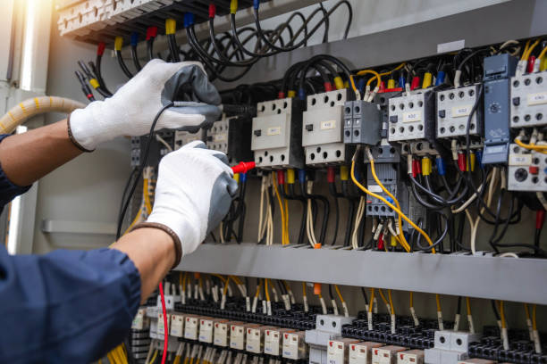 istock Checking the electrical system, an electrician is using an electric meter to check the electrical system at a control cabinet. for safety 2181345132