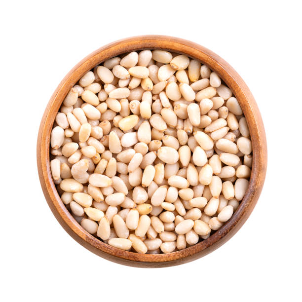 istock Pine nuts in a wooden bowl, isolated from above 2181347755