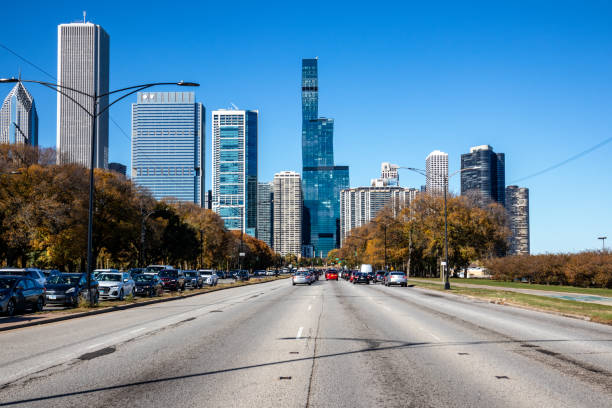 Traffic on Du Sable Lake Shore Dr with Chicago skyline in the background in autumn.