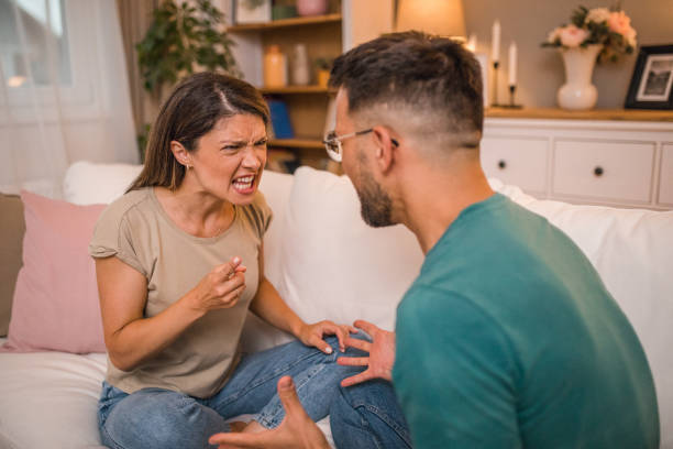 istock A woman and a man yell at each other while arguing at home 2181363721
