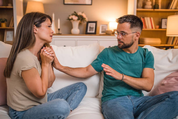 istock Heterosexual couple are quarreling while sitting on the sofa, at home 2181364036