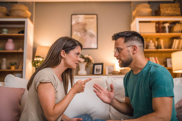 istock Married couple are quarreling while sitting on the sofa, at home 2181364144