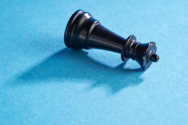 close up of queen chess piece on blue background