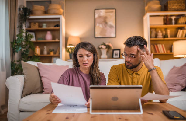 istock A loving couple is trying to solve debts and financial problems. They sort out financial debts and use a digital tablet 2181366850