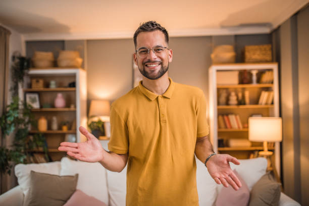 istock Handsome, smiling man looking directly at camera while standing in living room 2181369197