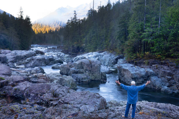 istock Mature man by a wilderness stream 2181369718