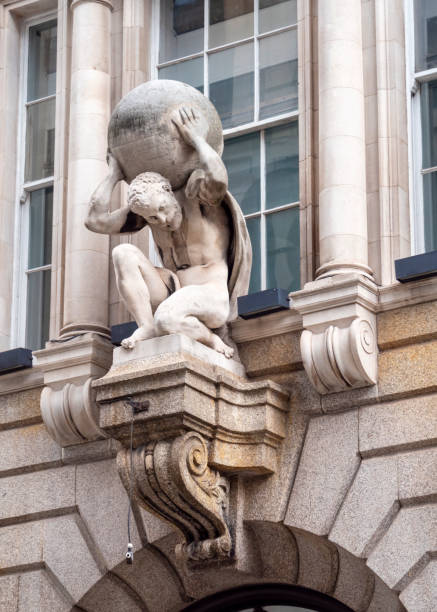The imposing sculpture of Atlas bearing the weight of the heavens on his shoulders situated over the main doorway of Atlas House, an Italianate building on the corner of King Street and Cheapside in the City of London, which was constructed by Thomas Hopper in 1836 and was the headquarters of the Atlas Assurance Company for over 130 years: the Atlas sculpture was created by Thomas Tyrell. The Atlas Assurance Company is no longer in existence.