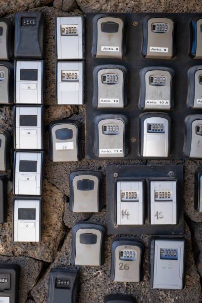 security boxes with password controlled locking for the storage of keys of holiday flats at the entrance of a building, problem of holiday apartments in cities security boxes with password controlled locking for the storage of keys of holiday flats at the entrance of a building, problem of holiday apartments in cities, vertical key package stock pictures, royalty-free photos & images