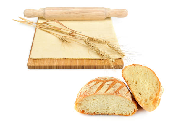 Dough, rolling pin, wheat ears and fresh wheat bread, isolated on white background. Free space for text. Collage.