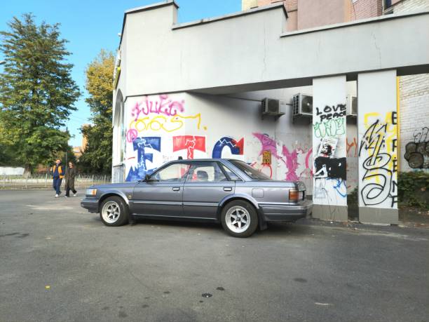 Retro cars of black color ride along the street