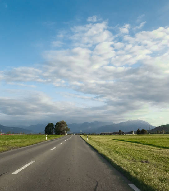 istock Road in alpine countryside. 2181377668
