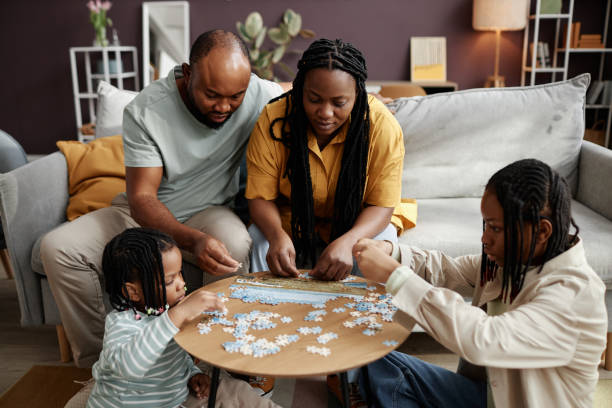 istock Family Solving Puzzle Together in Cozy Living Room 2181377809
