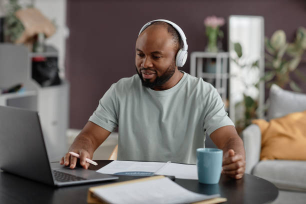 istock Listening to Music While Working on Laptop at Home 2181377844