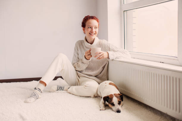istock Young Woman Drinking hot coffee at white room 2181380379
