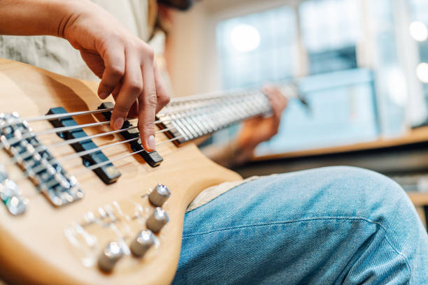 istock Man sitting in a home record studio playing electric guitar 2181380702