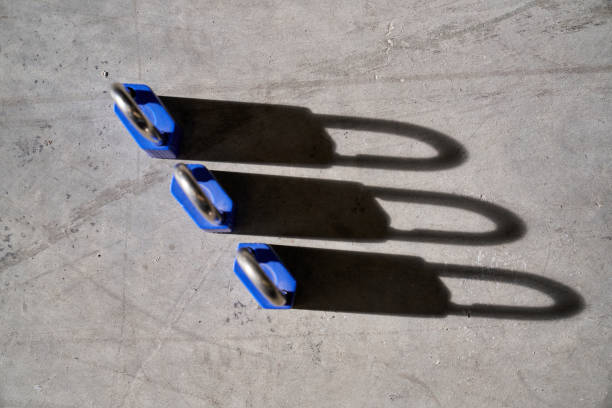 istock Set of secure locks placed on concrete floor 2181381308
