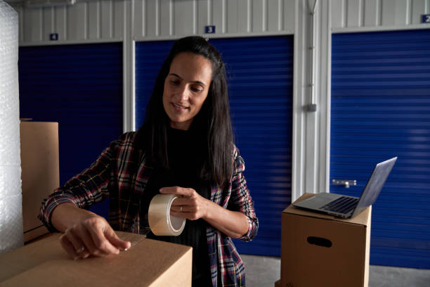 istock Content woman packing cardboard box 2181381324