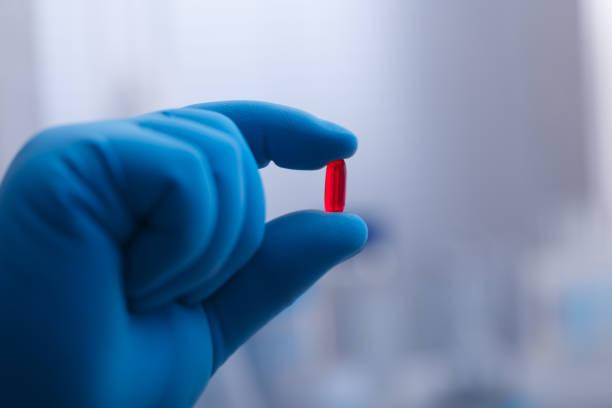 istock hand in a medical glove holds pills 2181382864