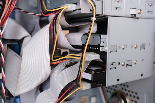 A computer system that has numerous wires protruding from its exterior components, indicating its complex connectivity and functionality