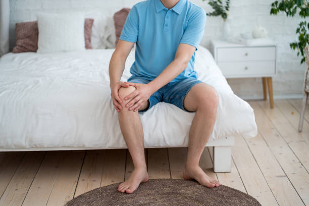 istock Knee pain, joint inflammation, arthritis and degenerative changes, man suffering from leg ache and doing self-massage 2181385302
