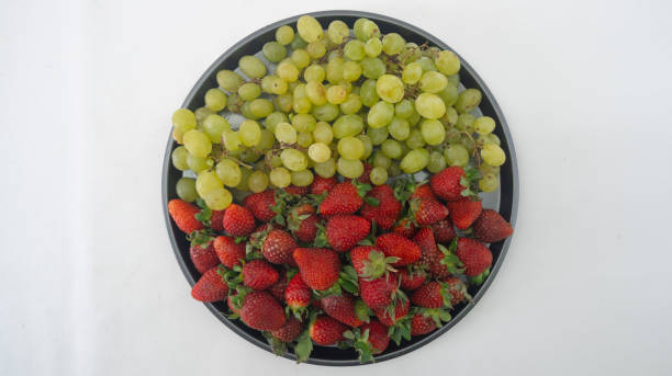 istock Various tropical fruits such as mango, banana, orange, grape and strawberry 2181385407