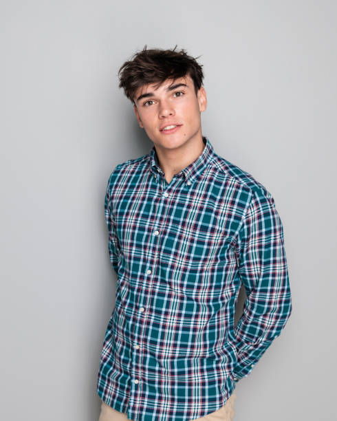 istock handsome young man in checkered shirt holding hands behind 2181386907