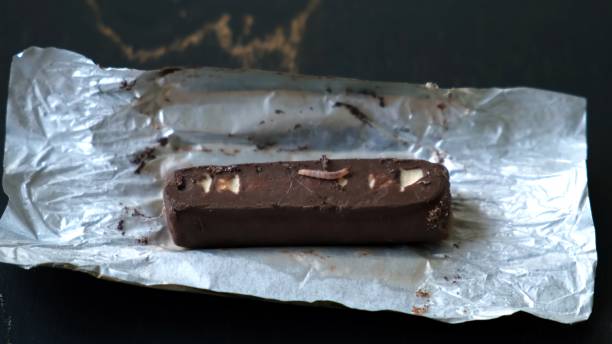 istock Worms crawls on chocolate candy. Crawling larvae and eggs laid on food. Not fresh spoiled product. A disgusting sight. Sickening and disgusting. Violation of storage conditions in a grocery store 2181387280